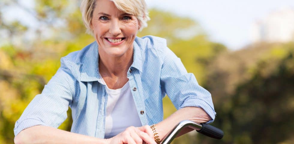 Woman out riding her bike, feeling better from holistic medicine