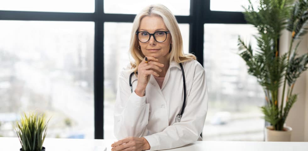 A ILADS doctor sitting at desk with plants